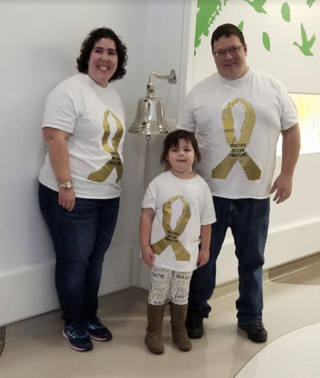 Piper and her parents ringing the bell at Nationwide Children's Hospital, celebrating when she officially became cancer free!